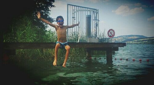 Woman jumping in swimming pool