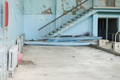 Abandoned olympic indoor swimming pool with two boots