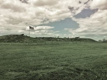 Scenic view of landscape against cloudy sky