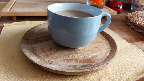 Close-up of coffee on table. hipster plates and dishes. wooden plate under coffee cup. hot drink. 