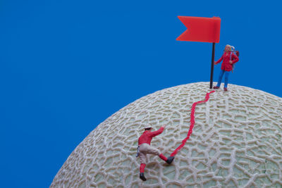 Low angle view of flag against blue sky