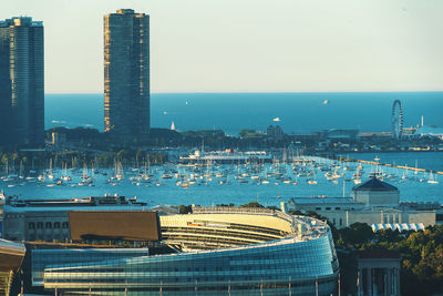 High angle view of buildings by sea against sky