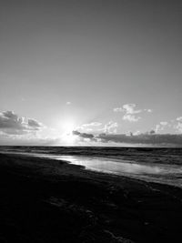 View of calm beach against blue sky