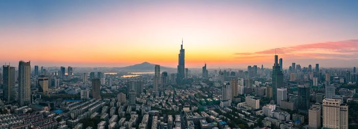 Aerial view of city against sky during sunset