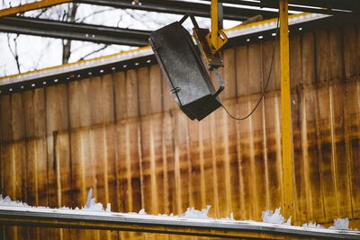 Low angle view of speaker hanging in an old factory hall