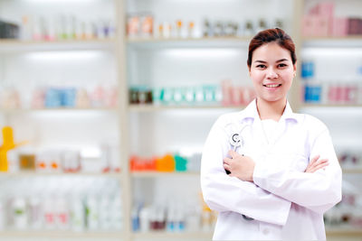 Portrait of smiling doctor standing in storage room at hospital 