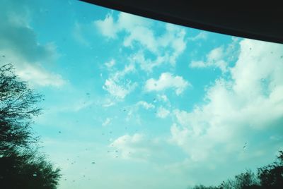 Low angle view of sky seen through glass window