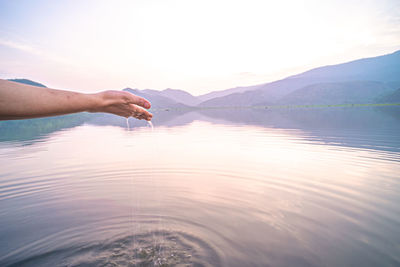 Cropped hand of woman holding water