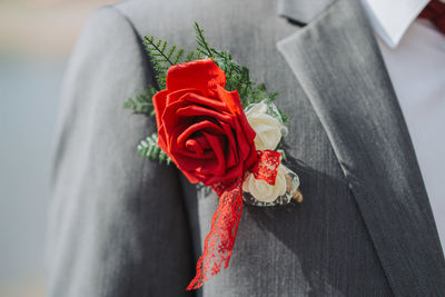 Midsection of bride holding bouquet