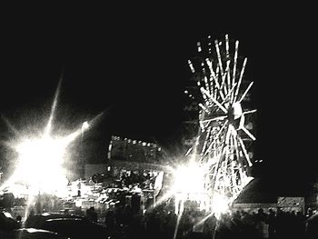 Low angle view of firework display at night