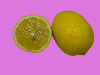 Close-up of lemon slice against pink background