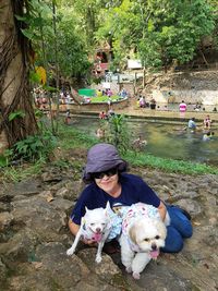 Woman with dog and plants in park