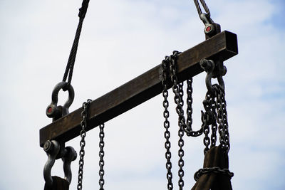 Low angle view of swing against sky