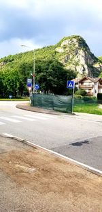 Road by street against sky