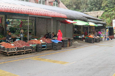 People at market stall in city