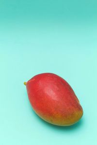 Close-up of apple against blue background