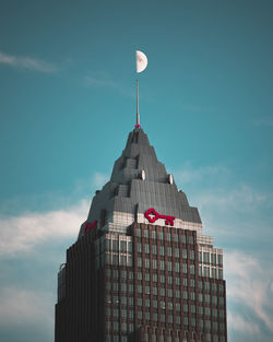 Low angle view of building against cloudy sky