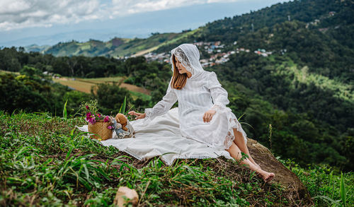 Woman sitting on field