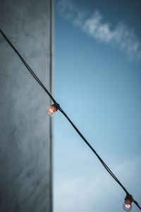 Low angle view of light bulb against sky