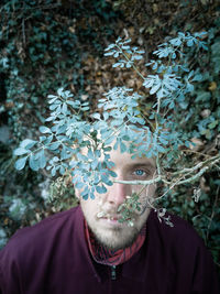 Portrait of man against plants