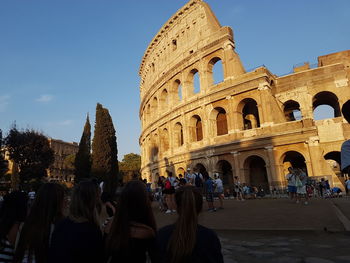 People at temple against sky