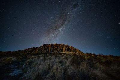 Low angle view of mountain against sky at night