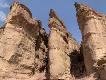 Low angle view of rock formation against sky