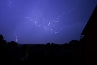 Low angle view of lightning in sky at night