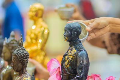 Close-up of human statue at market stall