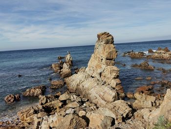 Rocks on beach against sky