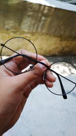 Close-up of hand holding eyeglasses