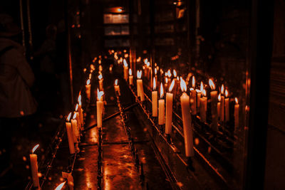 Illuminated candles at altar