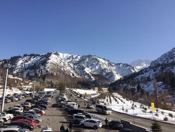 Cars parked on snow covered mountain