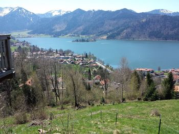 Scenic view of lake by buildings against mountains