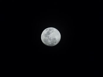 Low angle view of moon against clear sky at night