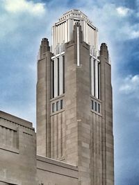 Low angle view of building against cloudy sky