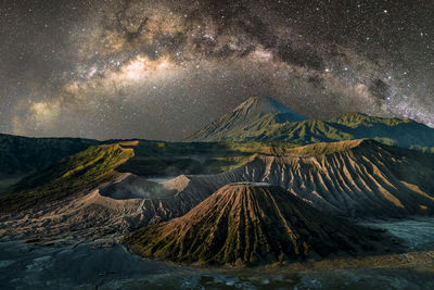 Scenic view of volcanic mountain against sky at night