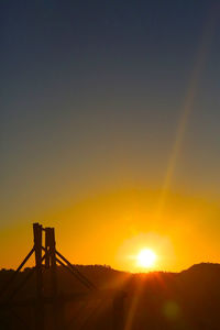 Silhouette bridge against sky during sunset