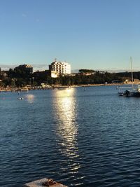 View of marina in sea against clear sky