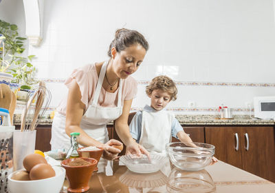 Woman and son cooking on table