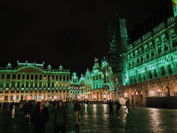 Group of people in illuminated building at night