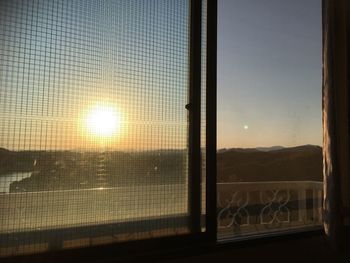 Close-up of window against clear sky during sunset