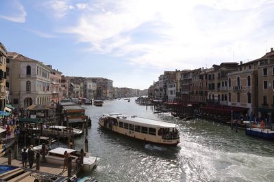 Boats in canal with buildings in background