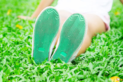 Low section of woman sitting on field