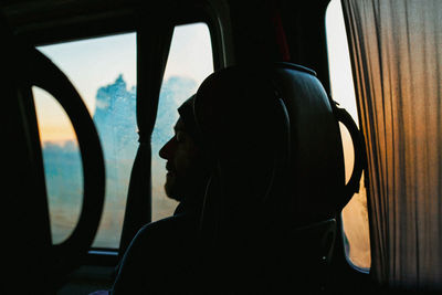 Portrait of man seen through airplane window