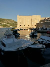 Boats moored at harbor