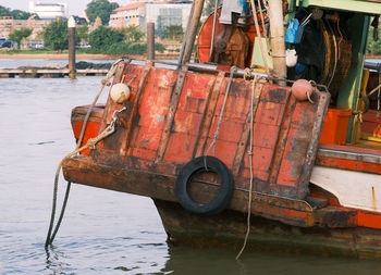 Abandoned boat moored on lake