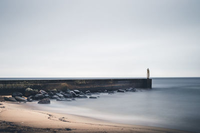 Scenic view of sea against clear sky. pier