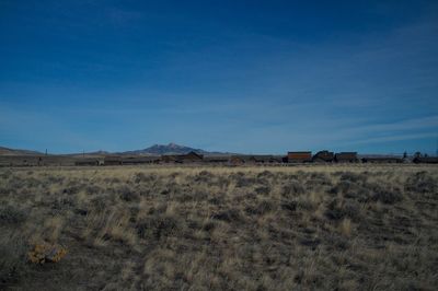 Scenic view of landscape against blue sky