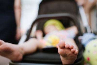 Close-up of boy relaxing on baby stroller